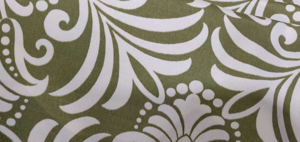 A close up of a floral fabric in green and white that we used to reupholster 2 chairs.